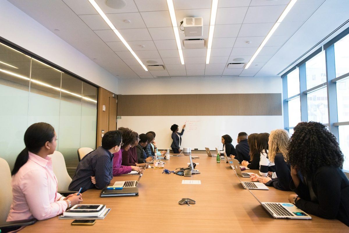 Advisors presenting to a management team in a boardroom