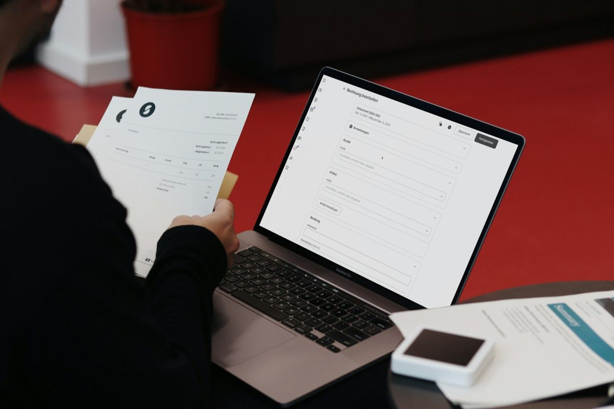 Invoices being processed on a laptop