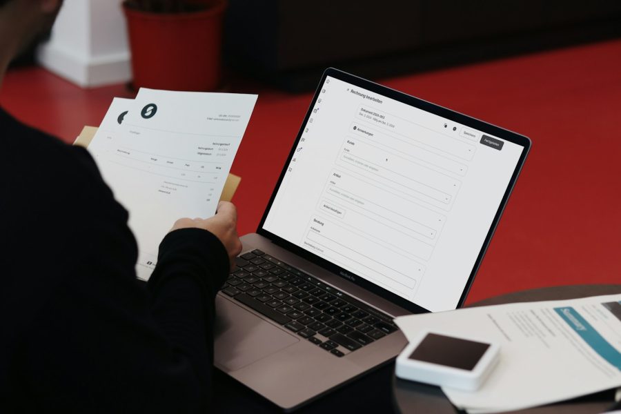 Invoices being processed on a laptop