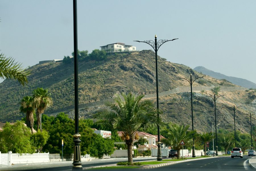 Street in Fujairah with mountains in the background