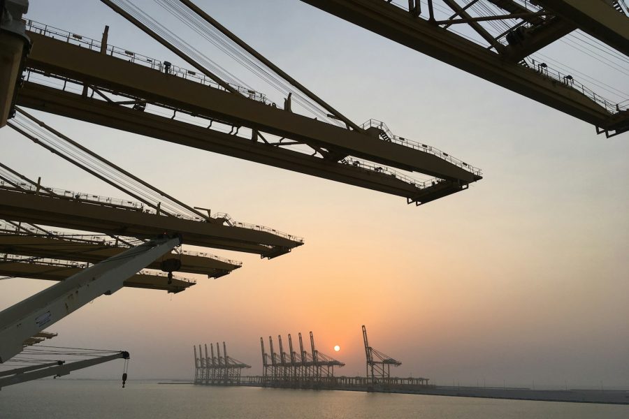 Container port cranes at sunset