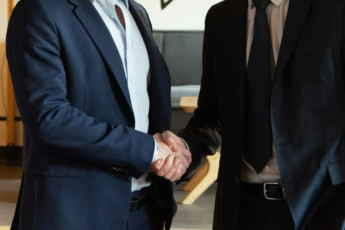 Two business partners shaking hands after forming a company