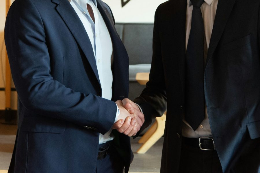 Two business partners shaking hands after forming a company