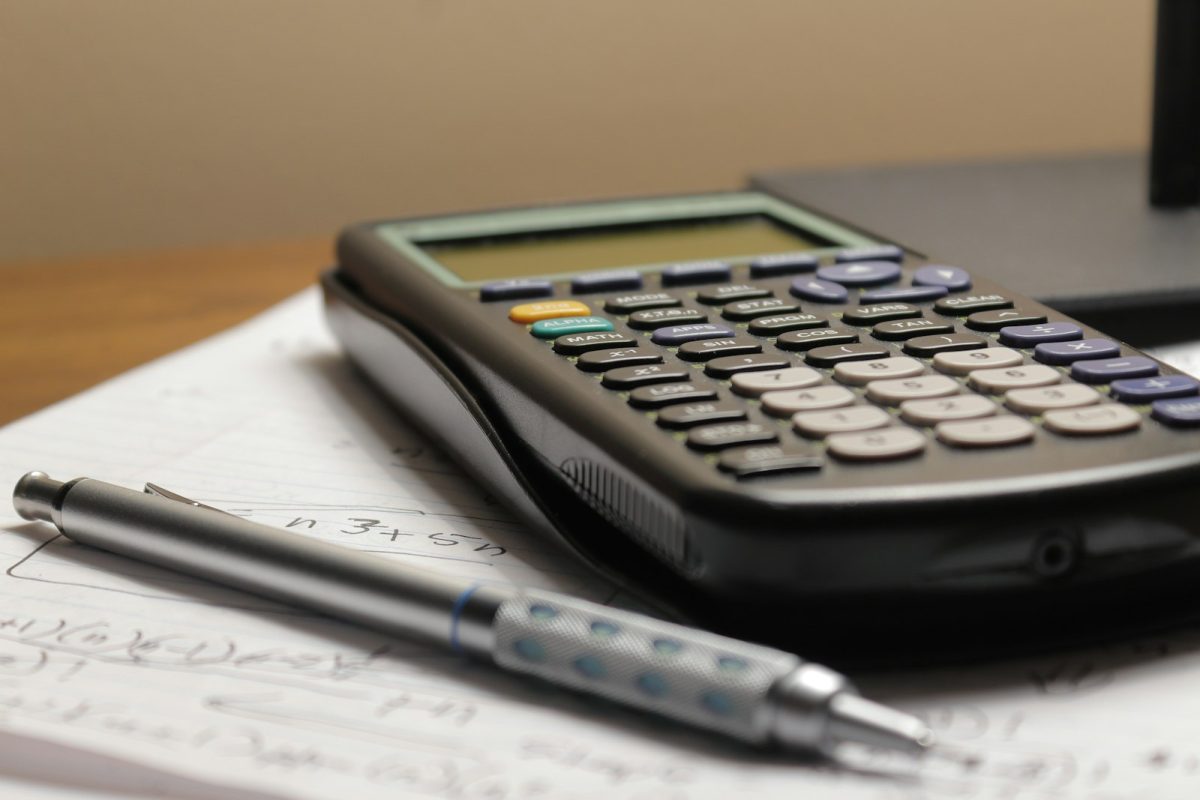 Calculator and pen on tax working papers